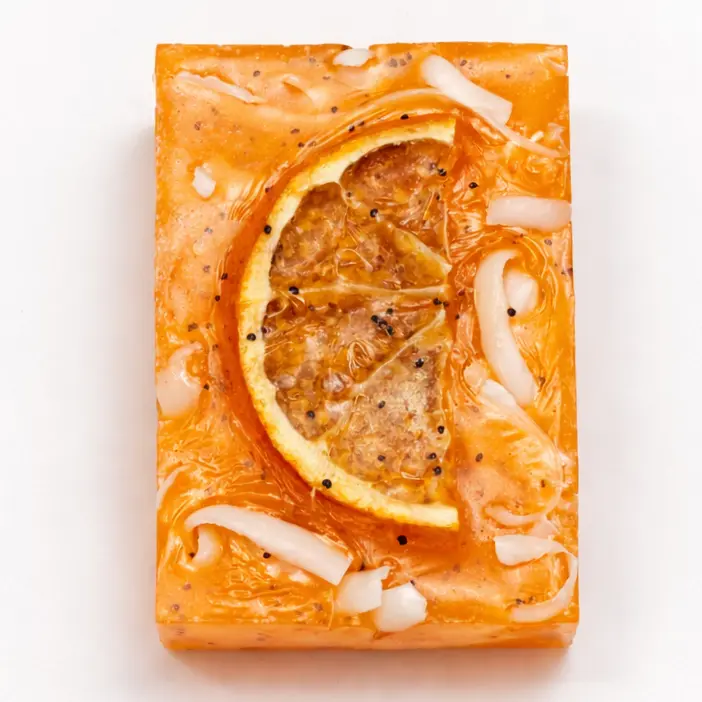 Handmade sweet orange soap with dried orange slice on white background