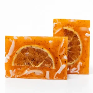 Handmade orange soap bar on white background