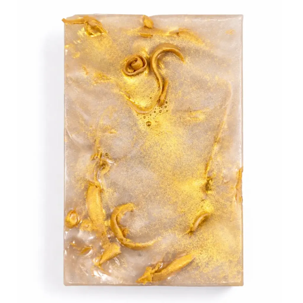 Coconut vanilla handmade soap with gold details on white background
