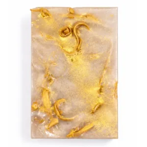 Coconut vanilla handmade soap with gold details on white background