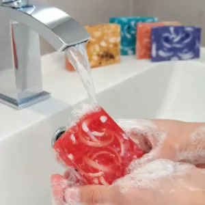 Cherry soap in use with rich foam under running water