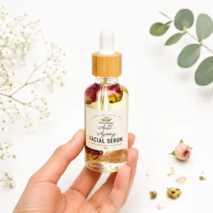 Karina Naturals daily rejuvenating facial oil with rosehip, argan and jojoba in a glass dropper bottle on a clean white background.