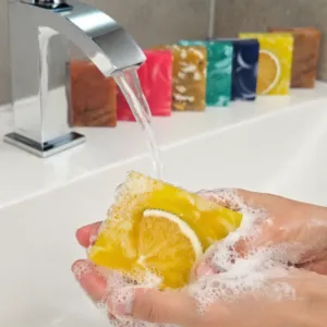 Lemon mint handmade soap being used under running water, rich foam, natural skincare by Karina Naturals