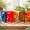 Colourful handmade natural soaps displayed on wooden tray Karina Naturals